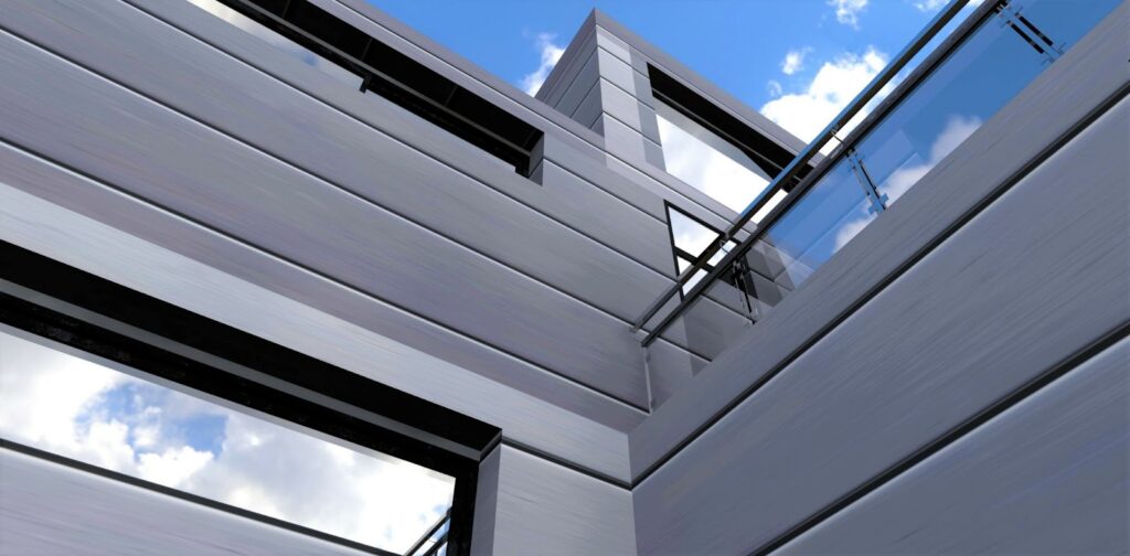 A building with aluminum clad windows against a sky background.