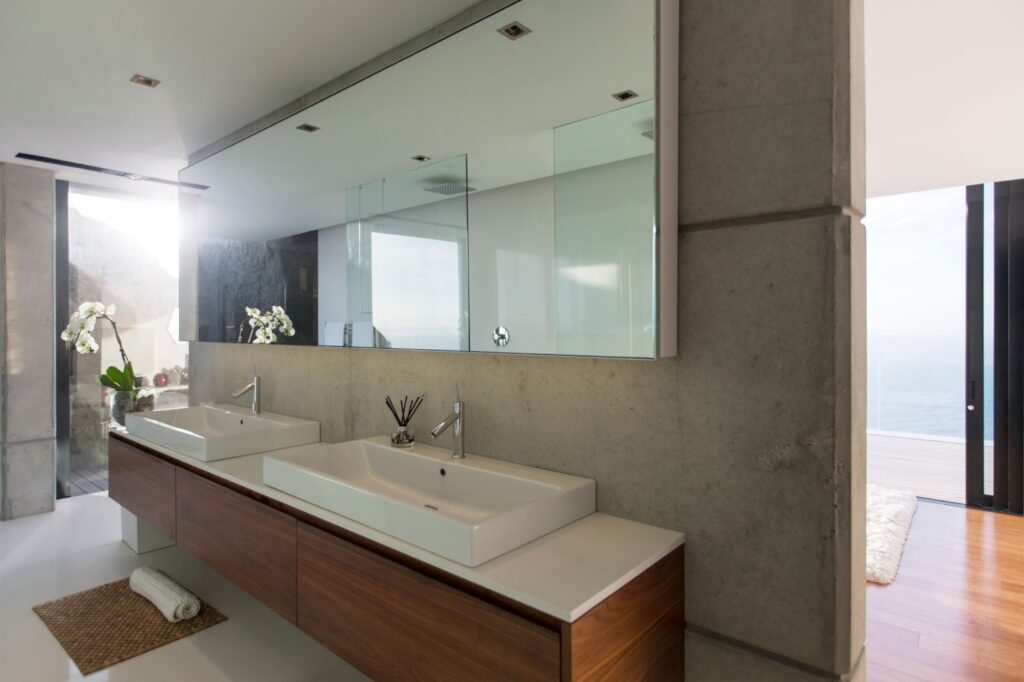 A modern bathroom featuring two sinks and a large mirror, ideal for a stylish residential upgrade.