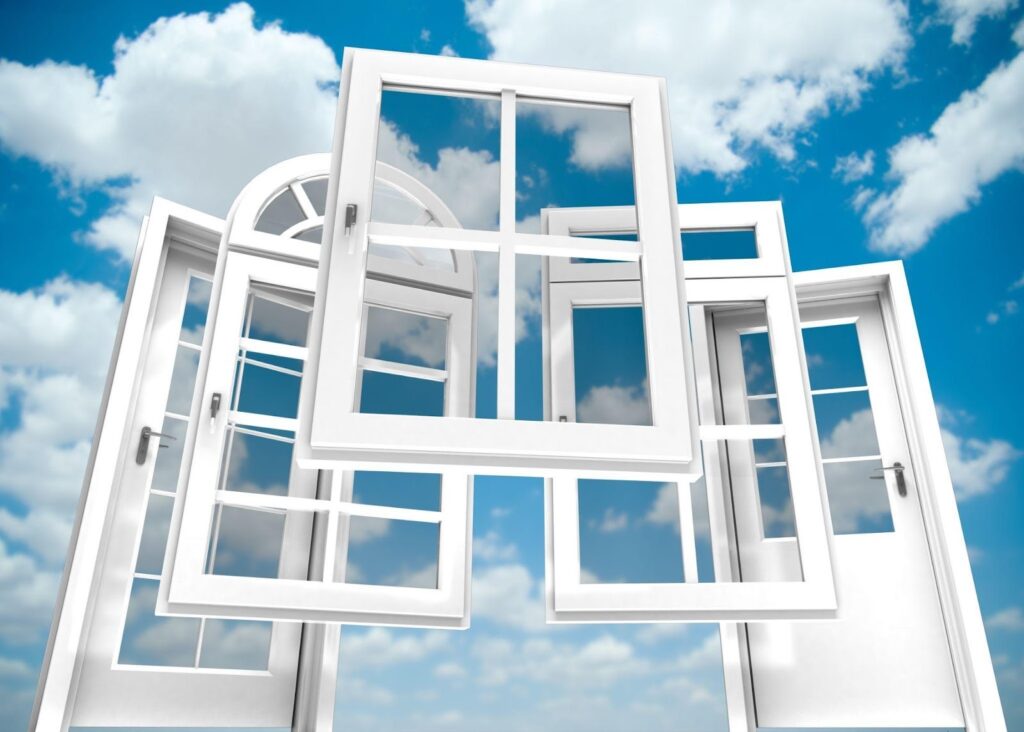 Three open windows with a view of a clear blue sky.